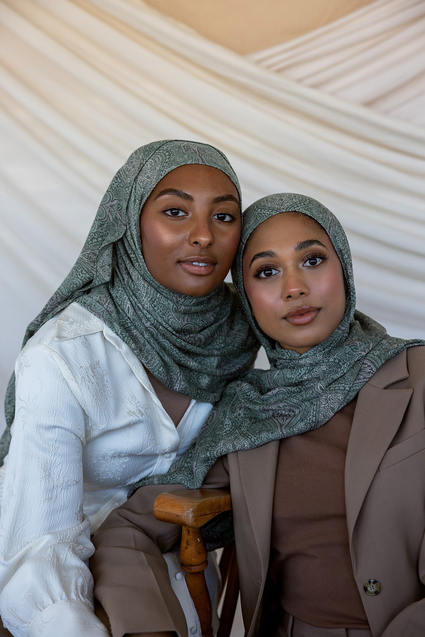 Two girls modeling in a green toned paisley printed hijab.