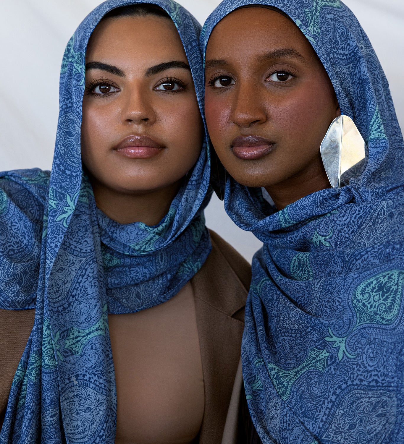 Two models styled in a blue toned paisley print hijab.