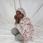 Model wearing soft modal hijab adorned with scattered floral accents and timeless elegance.