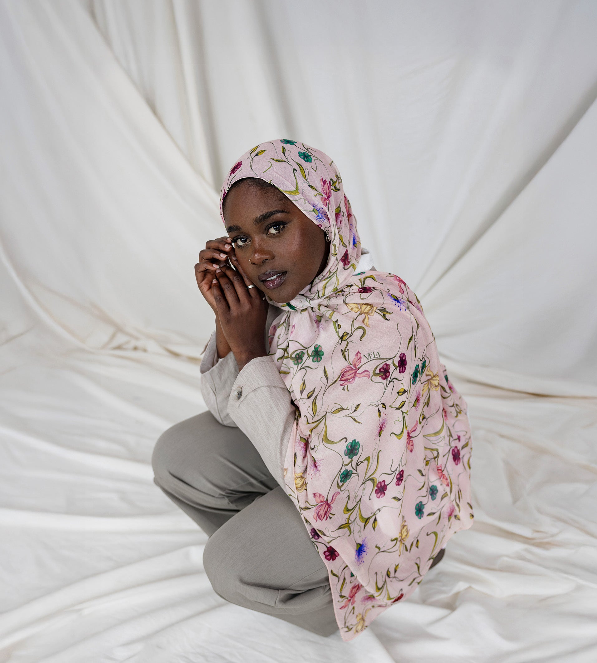 Model wearing soft modal hijab adorned with scattered floral accents and timeless elegance.
