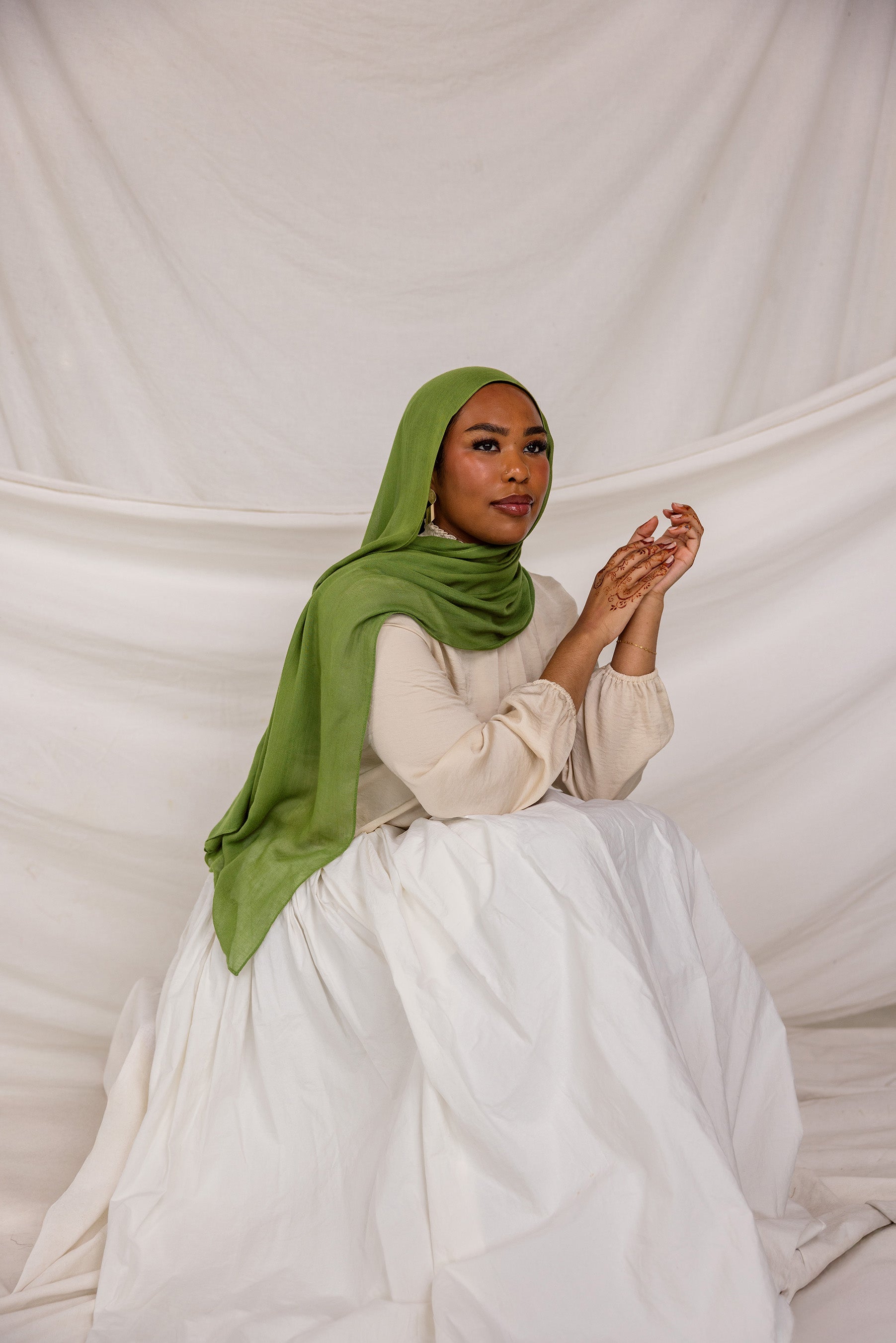 Model in three-quarter pose wearing the Fern Green hijab, emphasizing the fabric’s drape and flow.