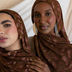 Two models styled in a brown red toned paisley print hijab.