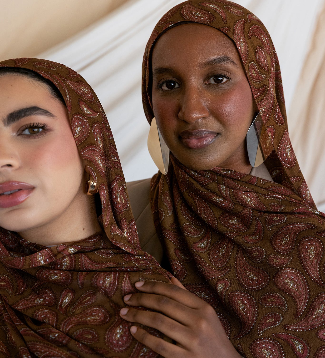 Two models styled in a brown red toned paisley print hijab.