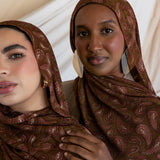 Two models styled in a brown red toned paisley print hijab.