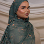 VELA hijab featuring a celestial-inspired print on a soft, lightweight fabric in rich teal tones.