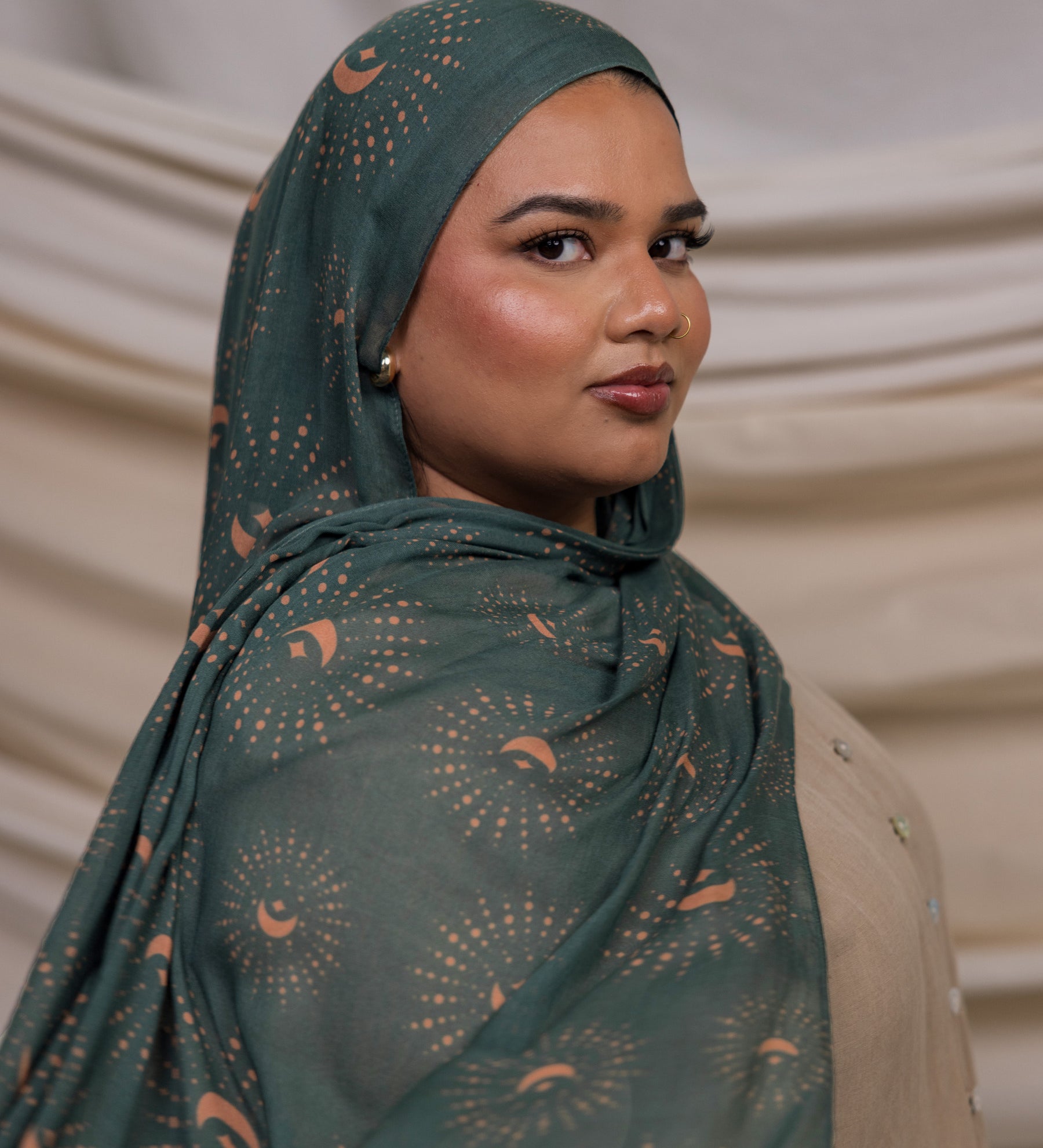 VELA hijab featuring a celestial-inspired print on a soft, lightweight fabric in rich teal tones.