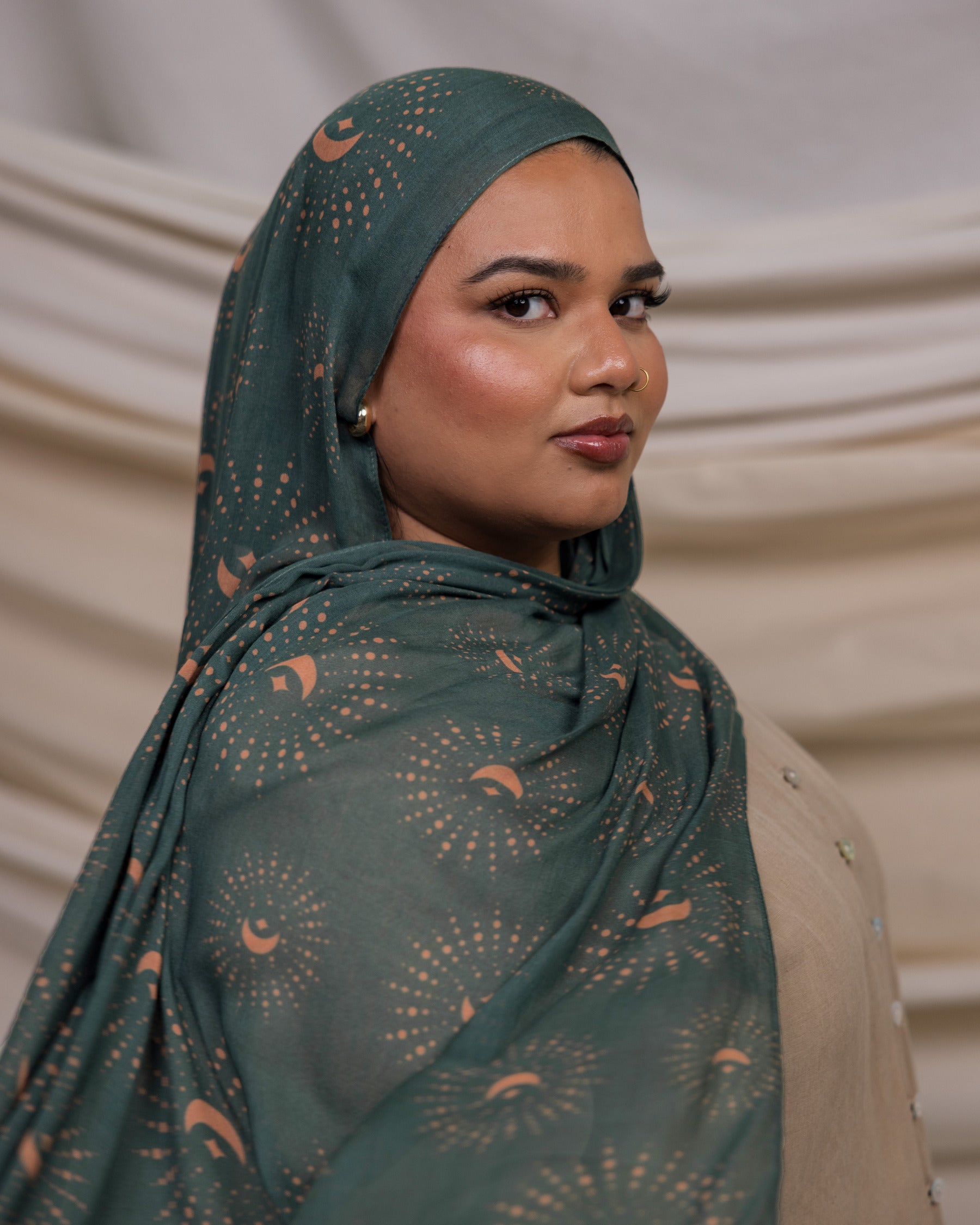 VELA hijab featuring a celestial-inspired print on a soft, lightweight fabric in rich teal tones.
