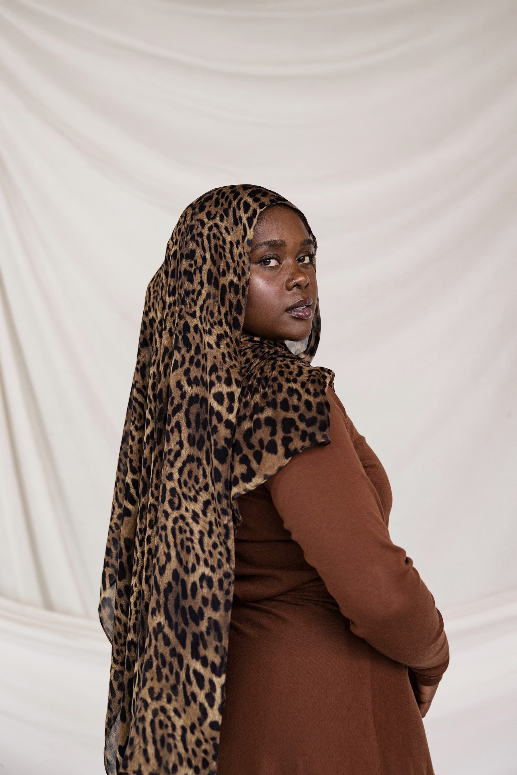 Model styled in a leopard print modal hijab.