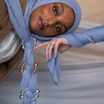 Model wearing Serenity Blue hijab with hijab hoops styled on the fabric.