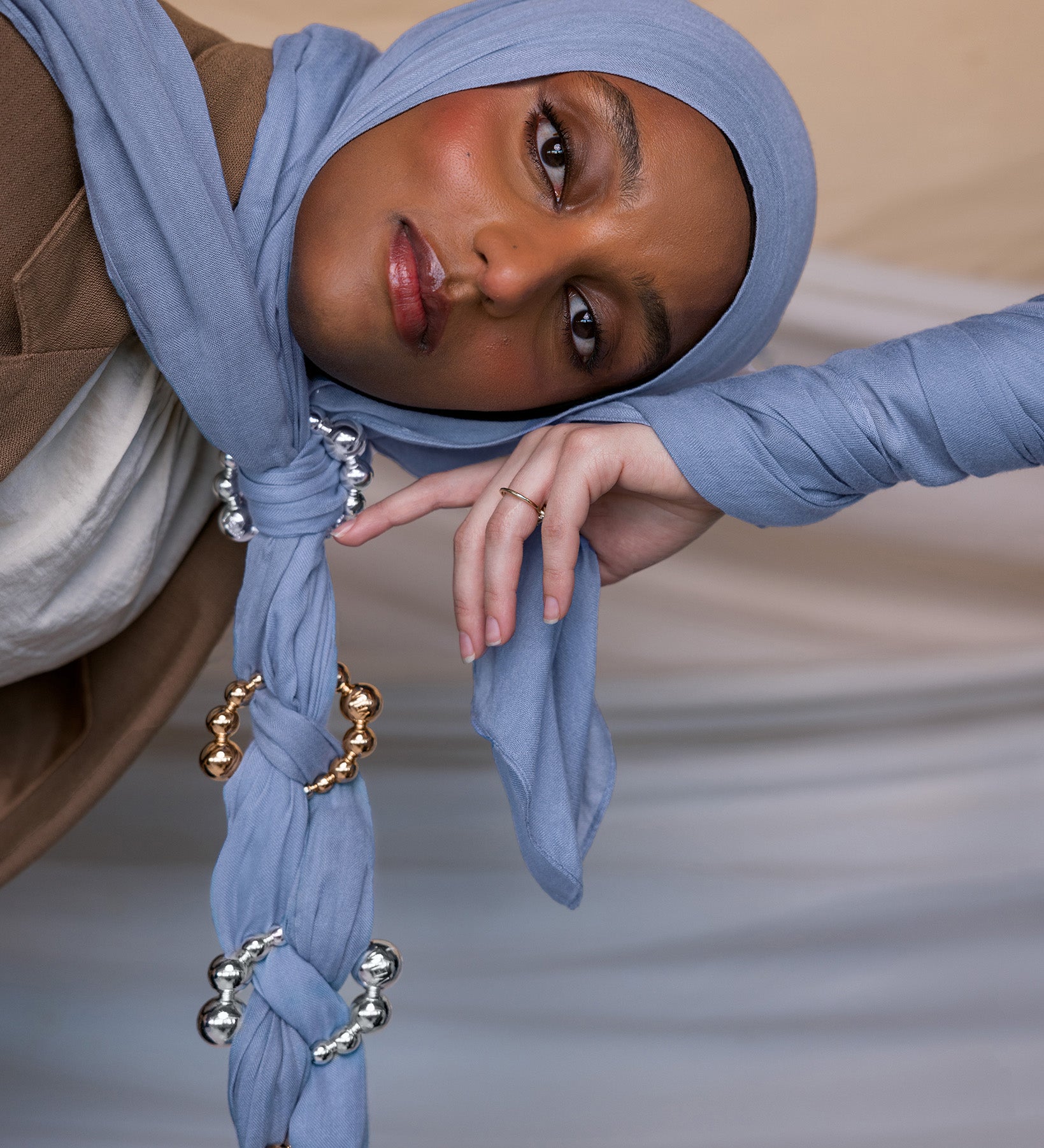 Model wearing Serenity Blue hijab with hijab hoops styled on the fabric.