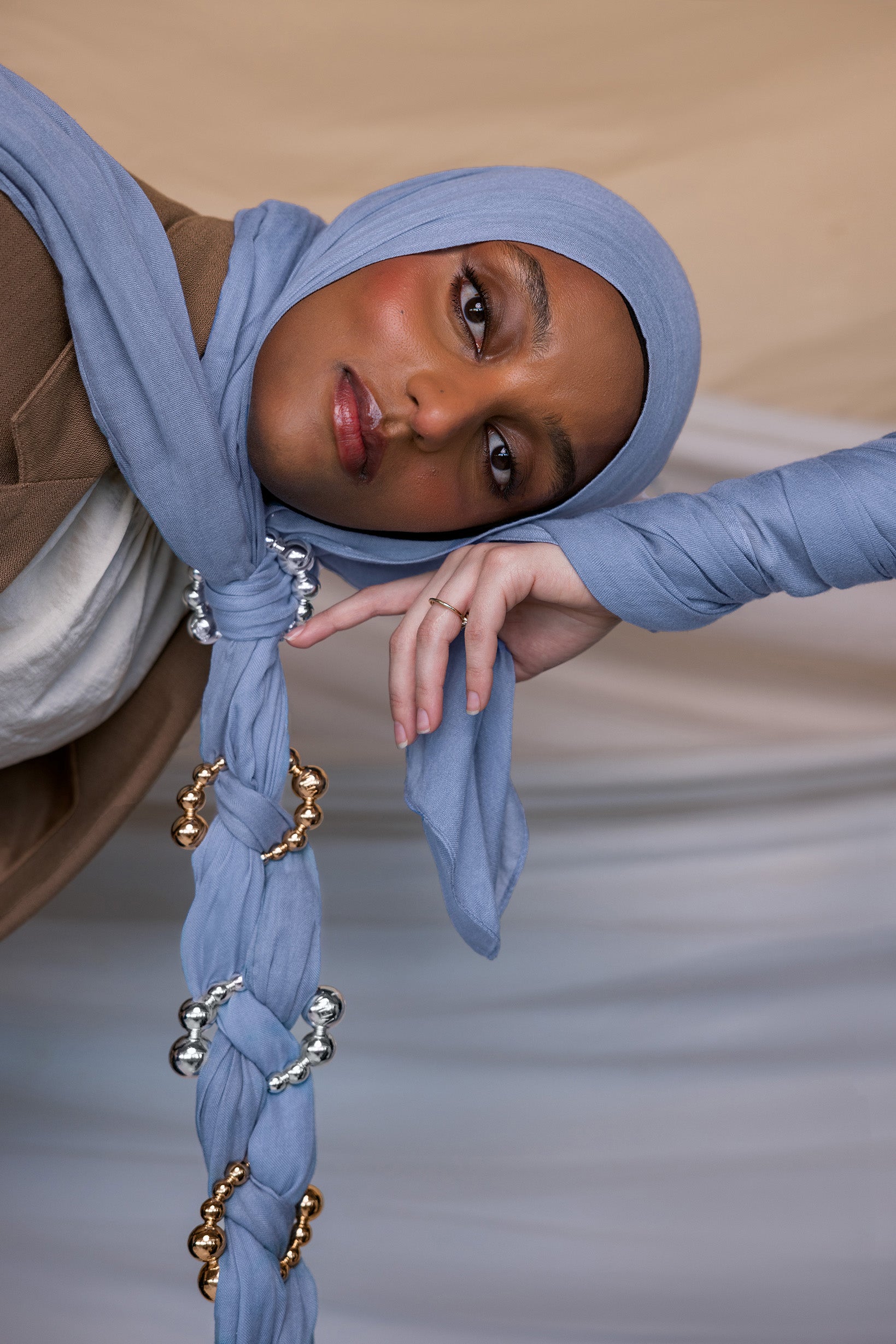 Model wearing Serenity Blue hijab with hijab hoops styled on the fabric.