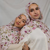 Two Models wearing floral hijab with sweet, delicate details and breathable, feather-light fabric.
