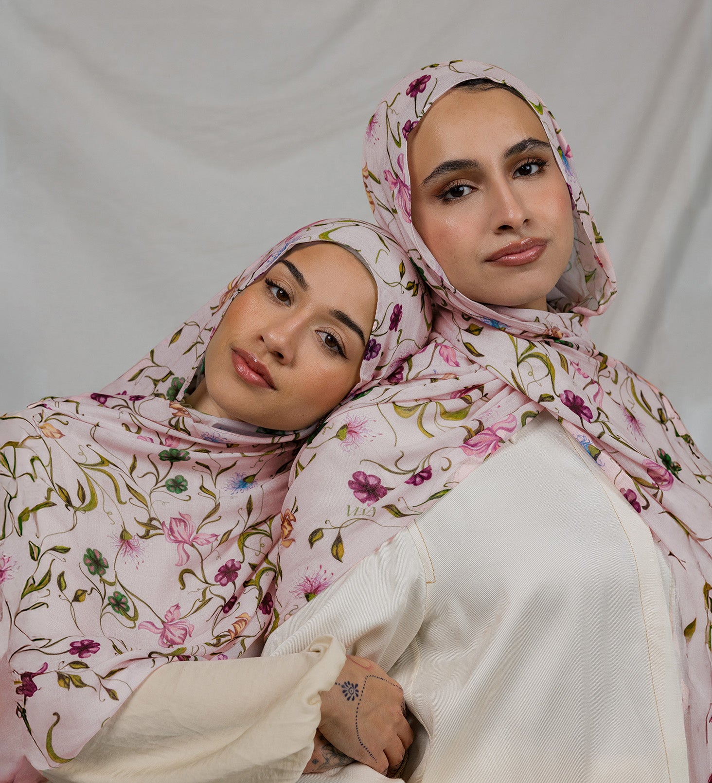 Two Models wearing floral hijab with sweet, delicate details and breathable, feather-light fabric.