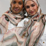 Two Models wearing breathable modal hijab crafted with a vibrant abstract sediment pattern.