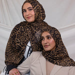 Two models wearing leopard print hijab on modal fabric.