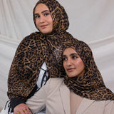 Two models wearing leopard print hijab on modal fabric.