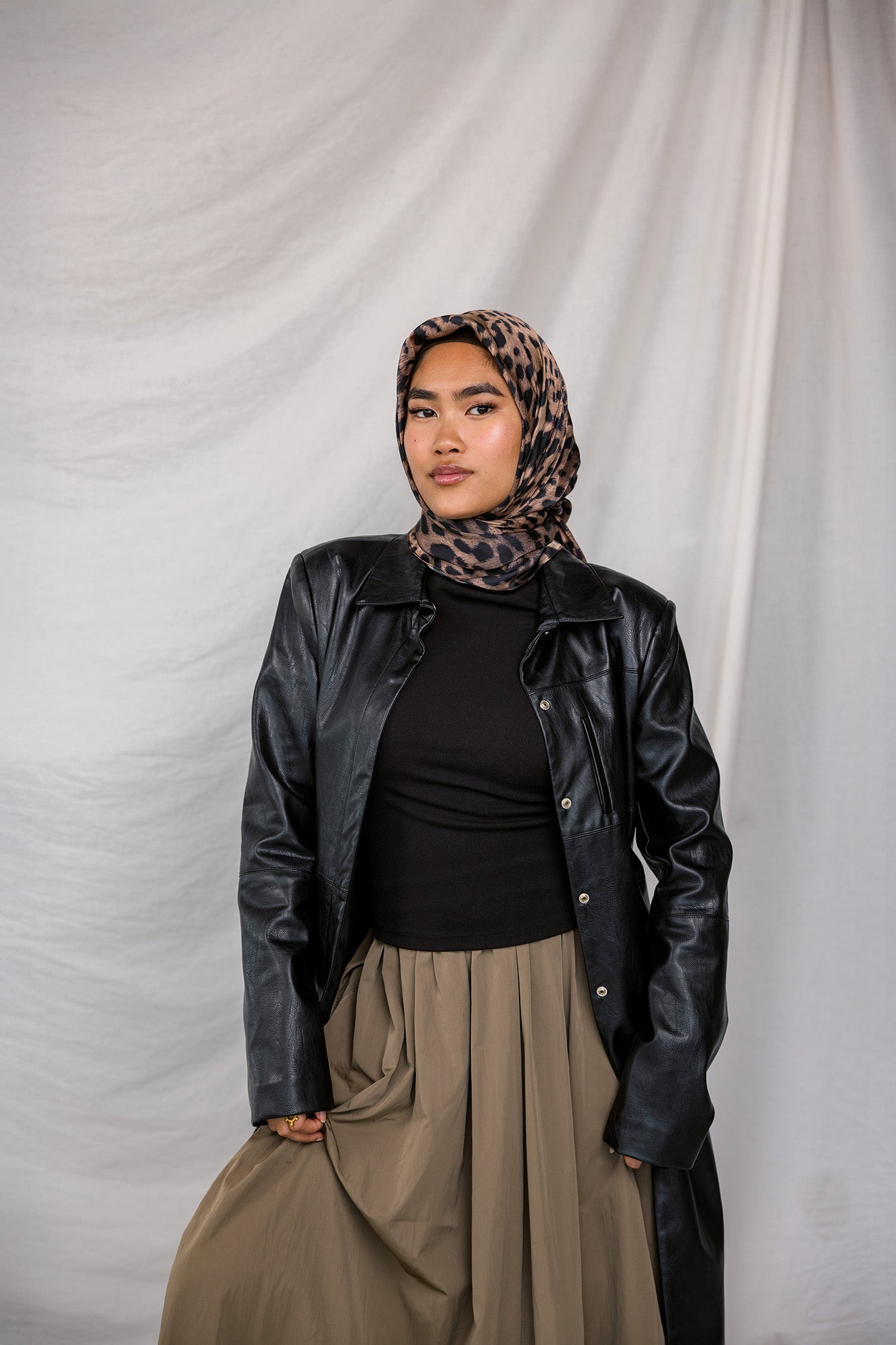A leopard print silk hijab styled on a model.