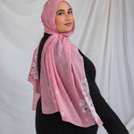 Model styled in a pink printed hijab featuring sakura pink and white cherry blossoms.