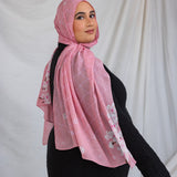 Model styled in a pink printed hijab featuring sakura pink and white cherry blossoms.