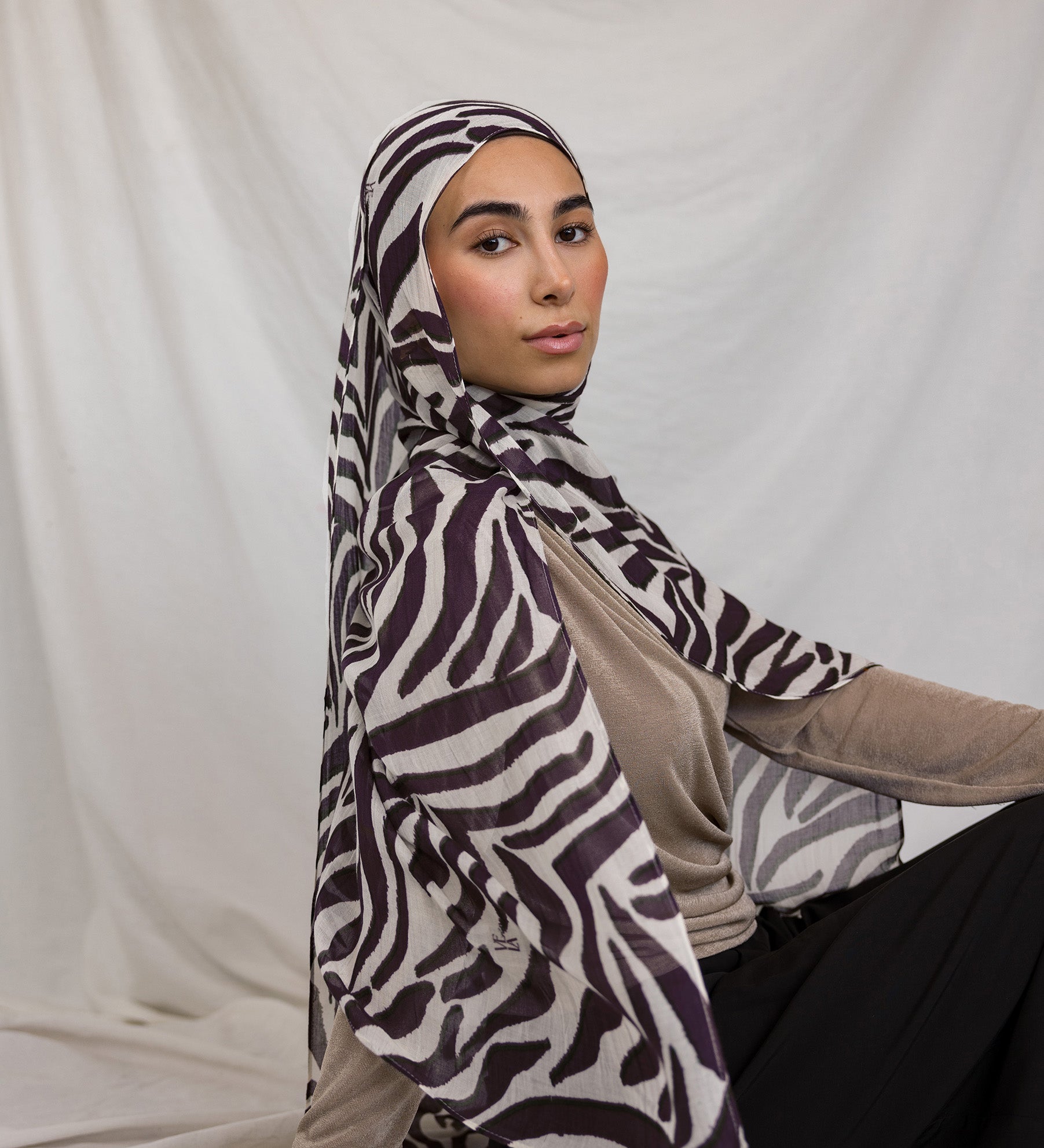 Model shown wearing VELA's Zebra print, which features deep berry toned stripes like a zebra, on a white base.