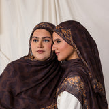 Side profile shot of two women styled in Chocolate Paisley hijabs.
