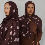 Two models styled in a brown printed hijab with pink and white cherry blossoms.