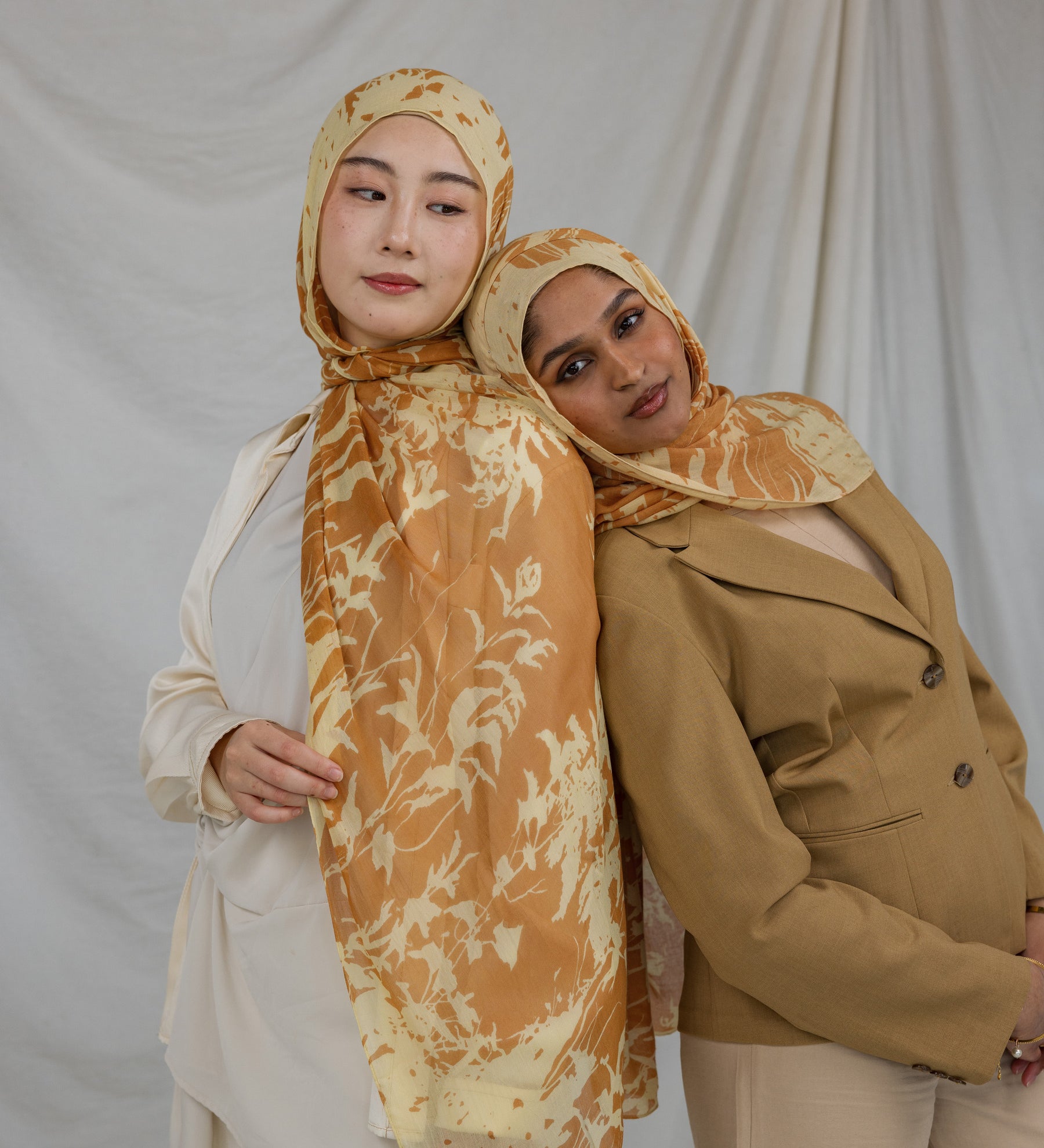 Two Models wearing flowy modal hijab featuring a subtle nature print and all-day comfort.
