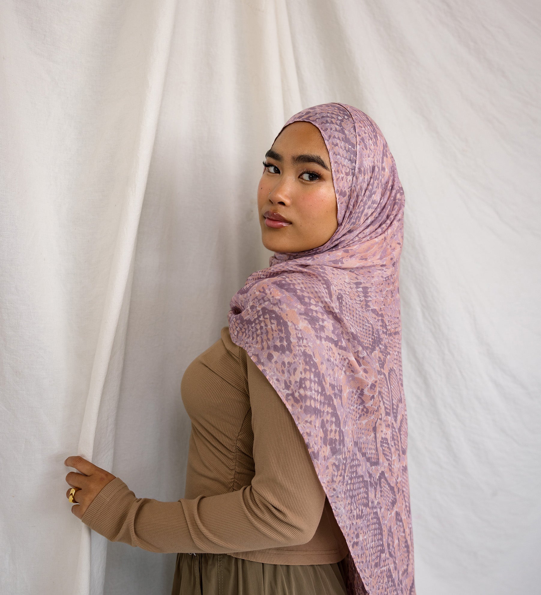 Model in VELA pink and purple snakeskin inspired print.