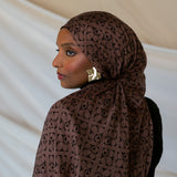 Model wearing brown Art Deco styled print hijab.