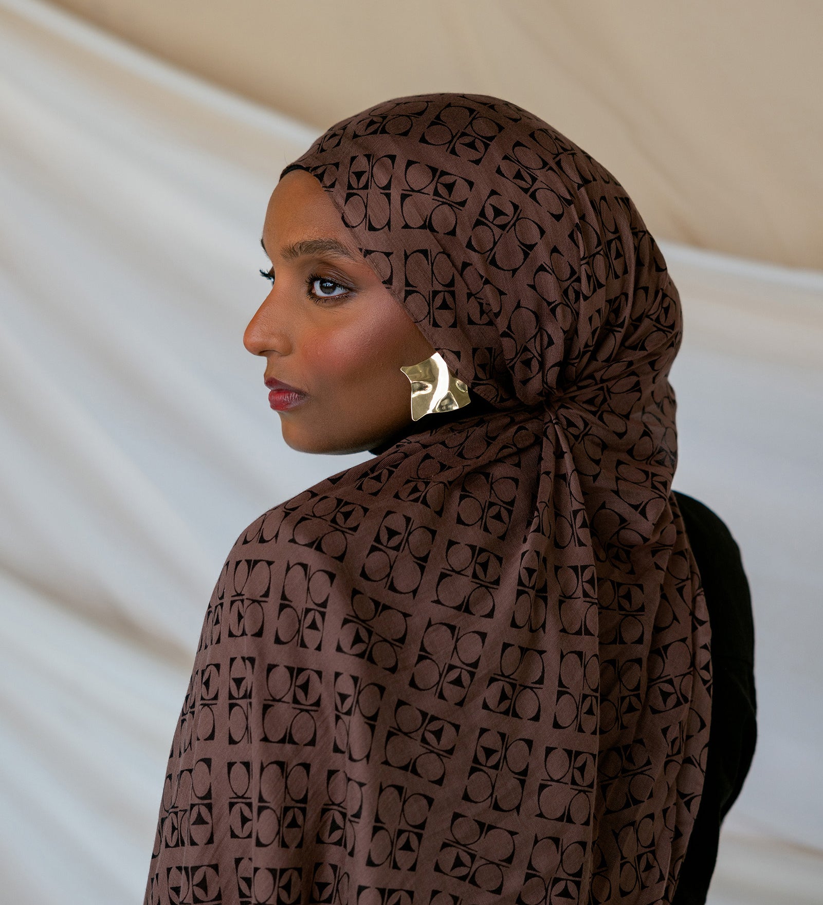 Model wearing brown Art Deco styled print hijab.