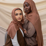 Two models wearing Toasted Pecan hijab against backdrop.