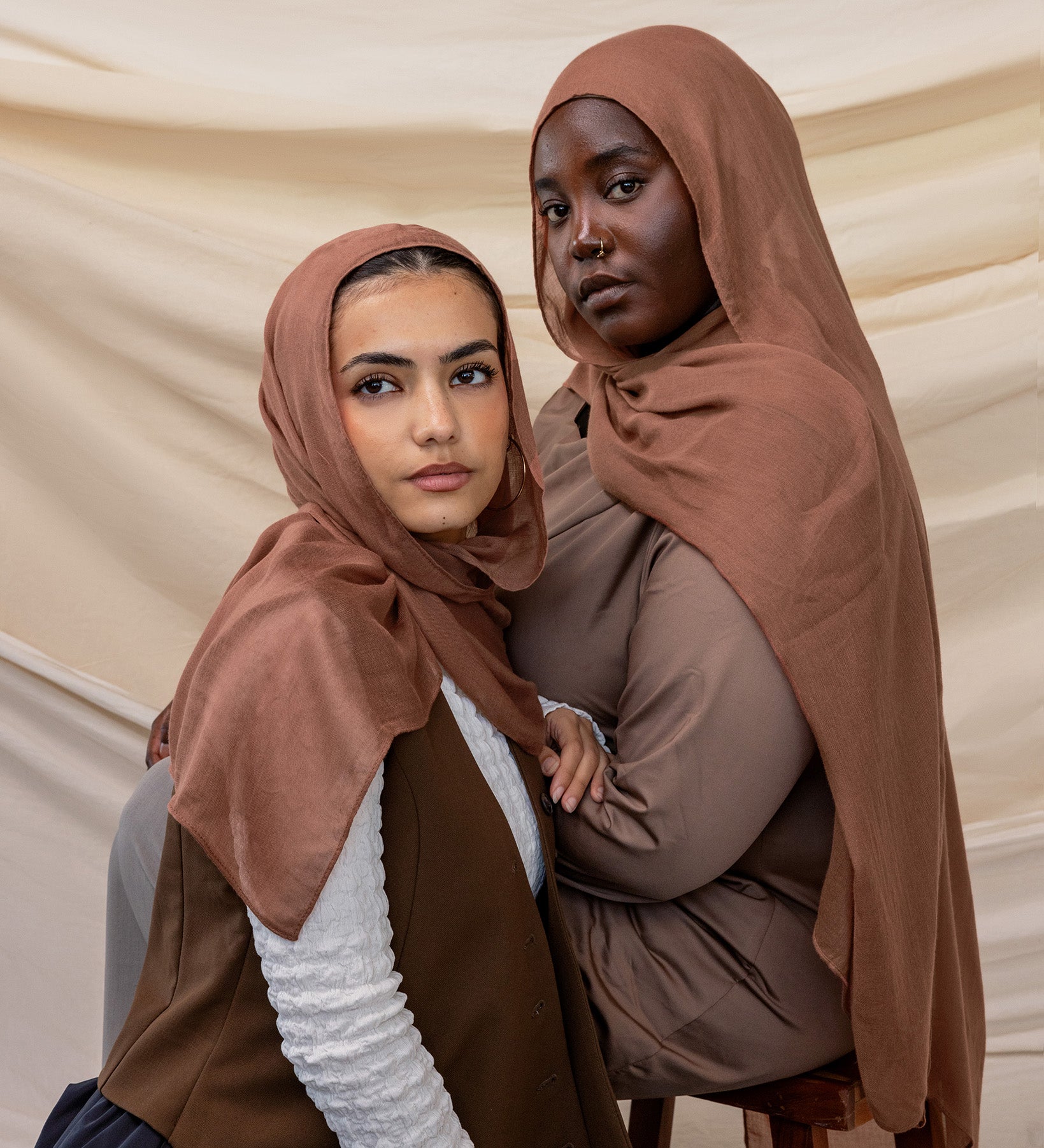 Two models wearing Toasted Pecan hijab against backdrop.