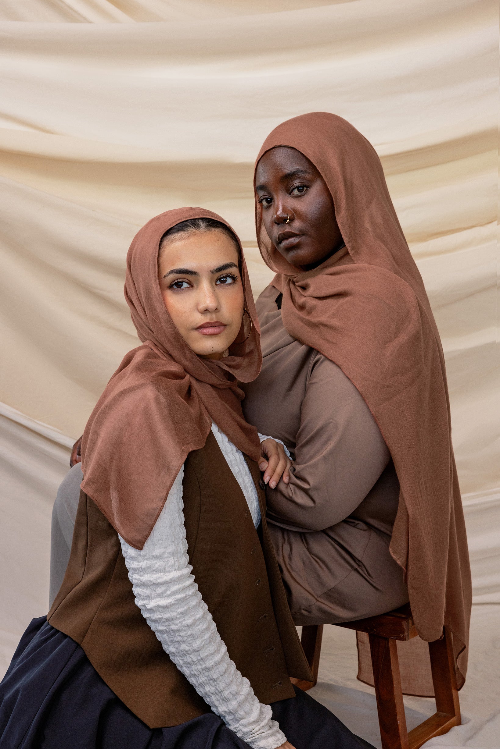 Two models wearing Toasted Pecan hijab against backdrop.