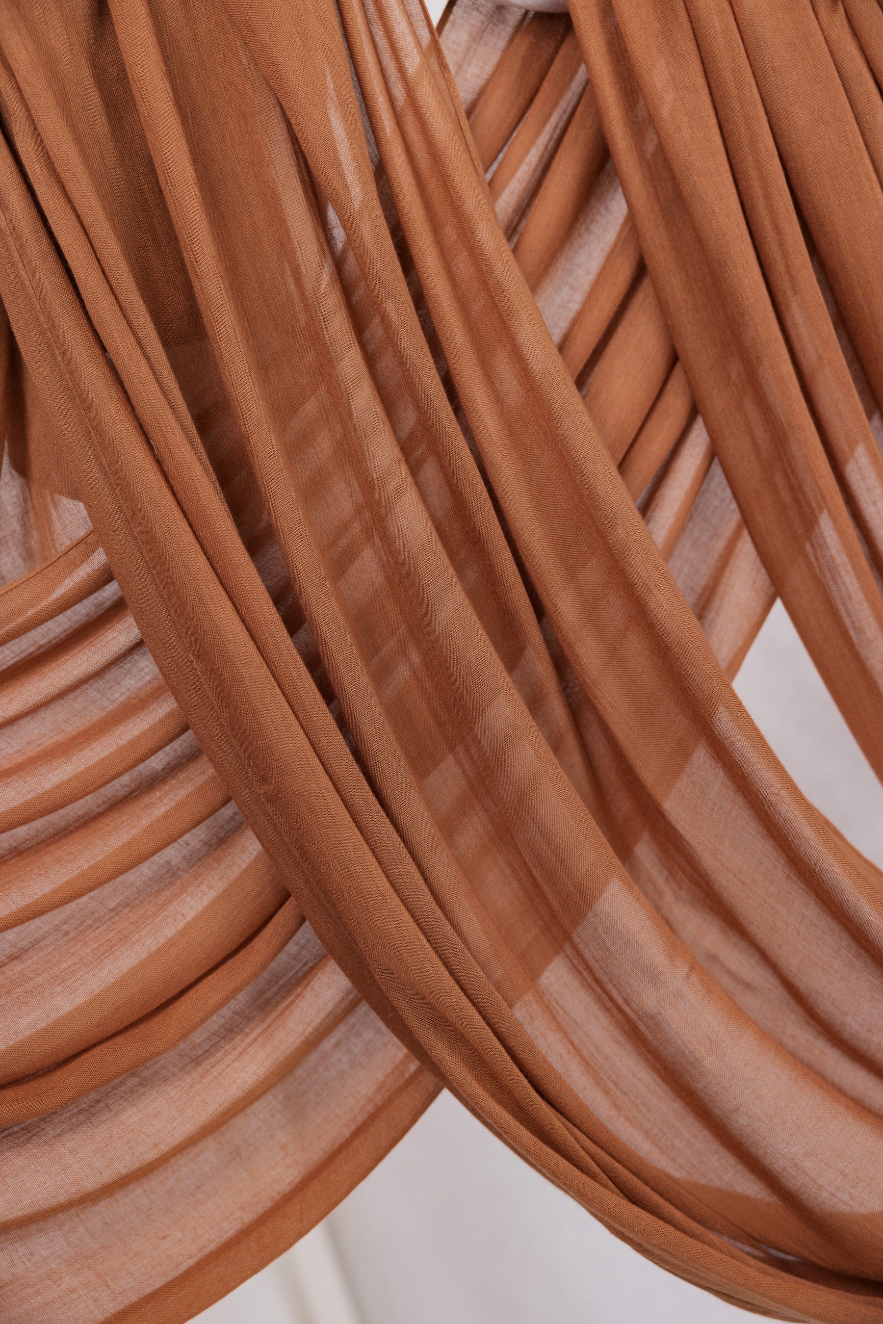 Cinnamon-toned modal hijab by VELA, bringing cozy energy and subtle strength to your wardrobe staples.