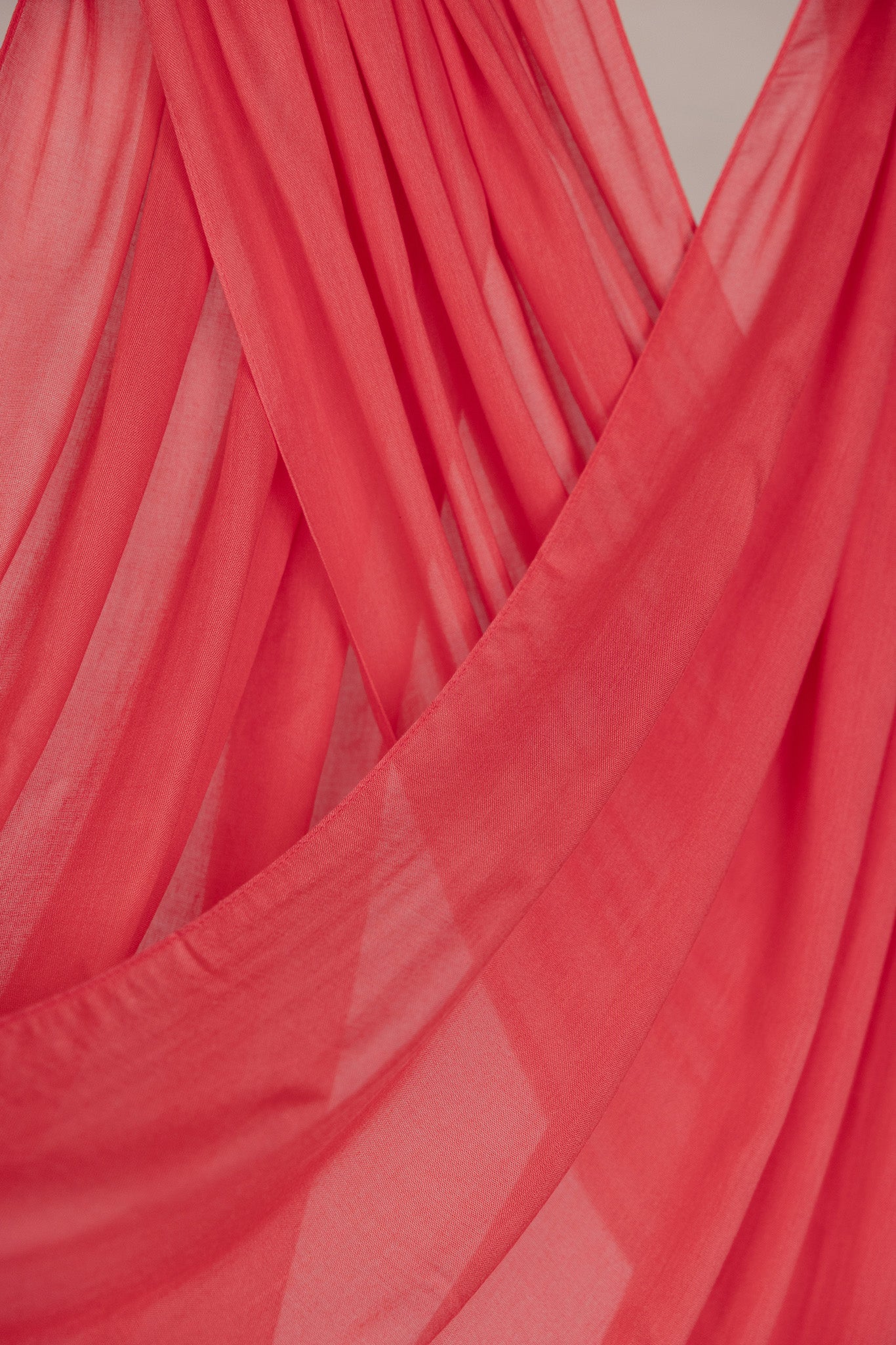 Close-up of pink coral hijab with a draped effect