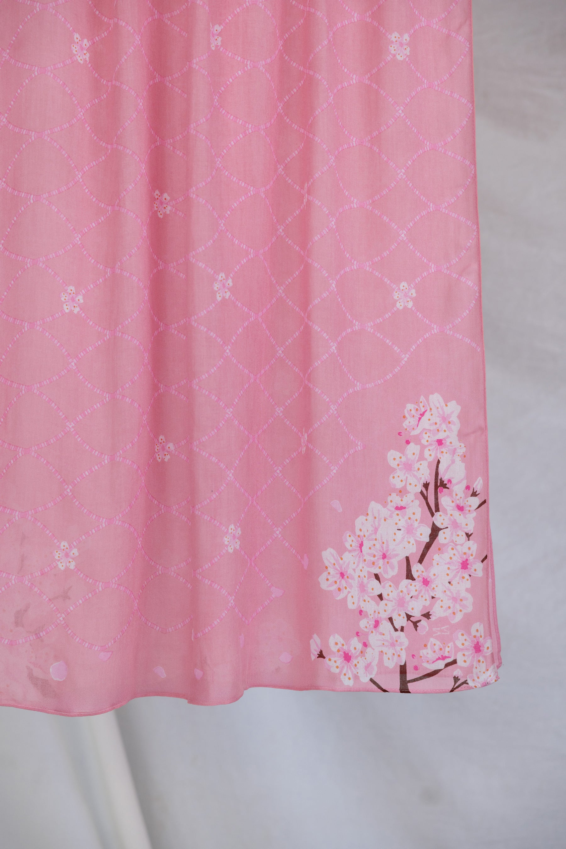 A product image showing a pink sakura printed hijab.