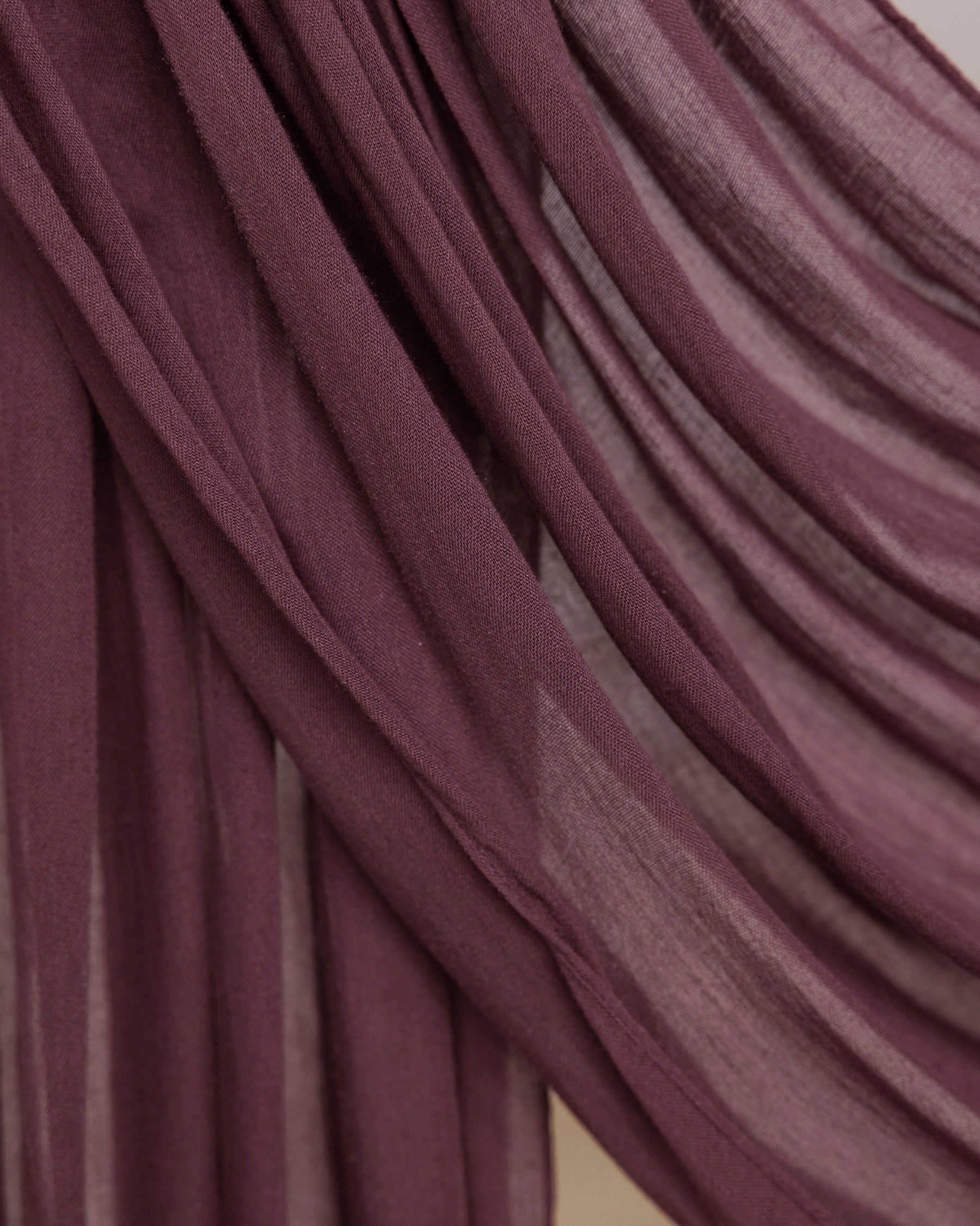 Rosewood hijab being draped in front of backdrop.