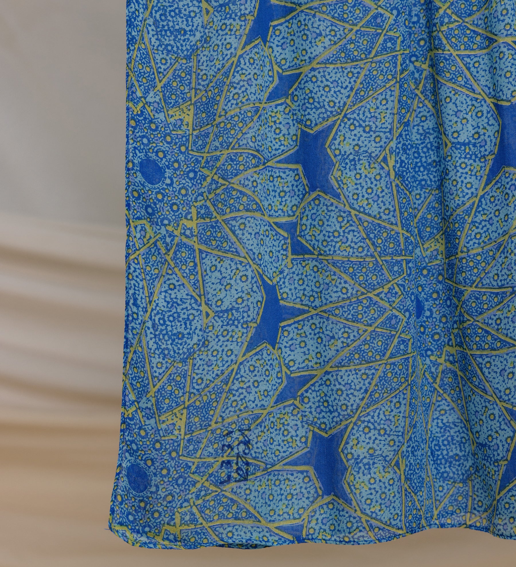 Lightweight modal hijab with keffiyeh-style details and mosque-inspired motifs.