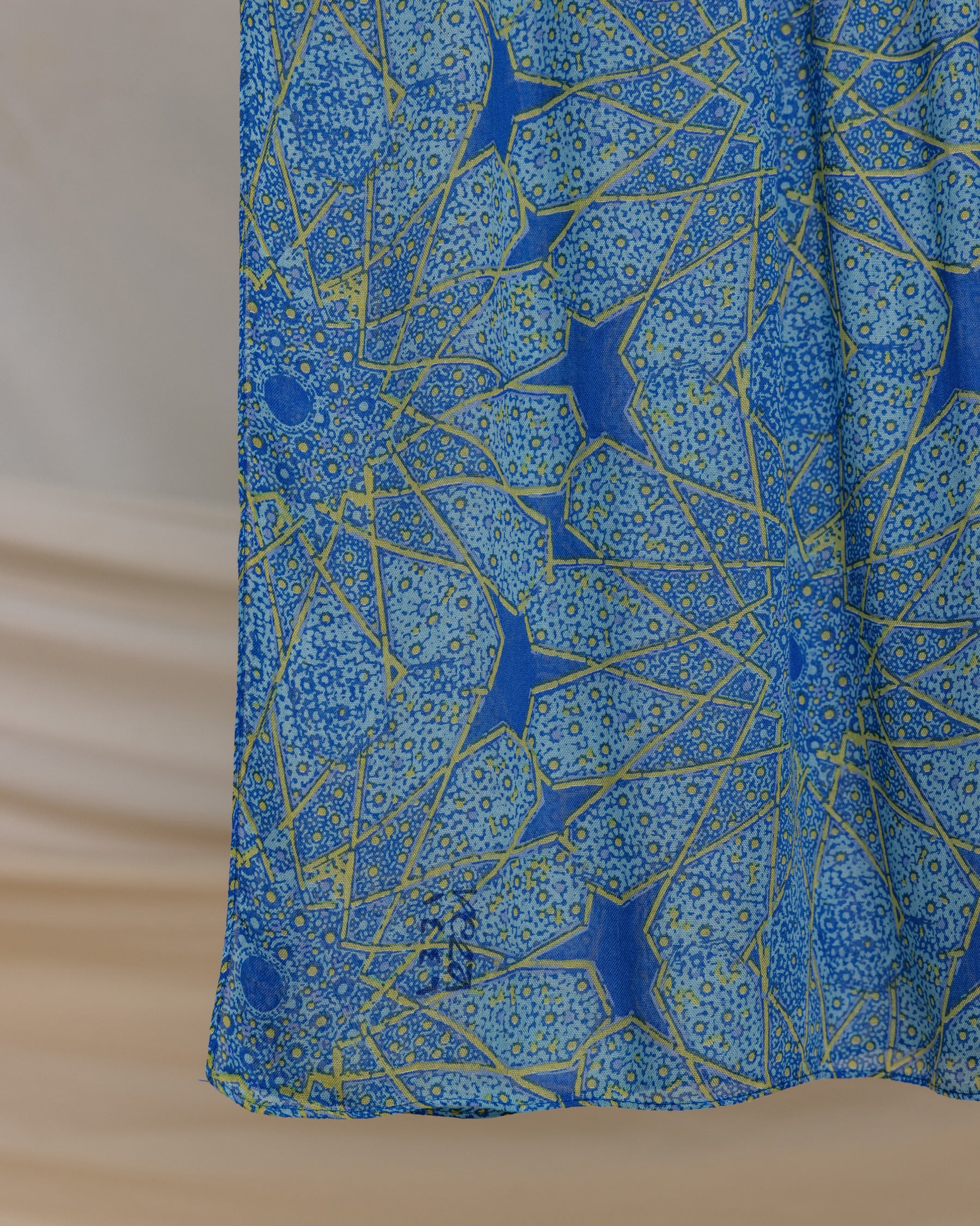Lightweight modal hijab with keffiyeh-style details and mosque-inspired motifs.