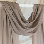 Truffle Mushroom hijab draped in front of backdrop.