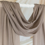 Truffle Mushroom hijab draped in front of backdrop.