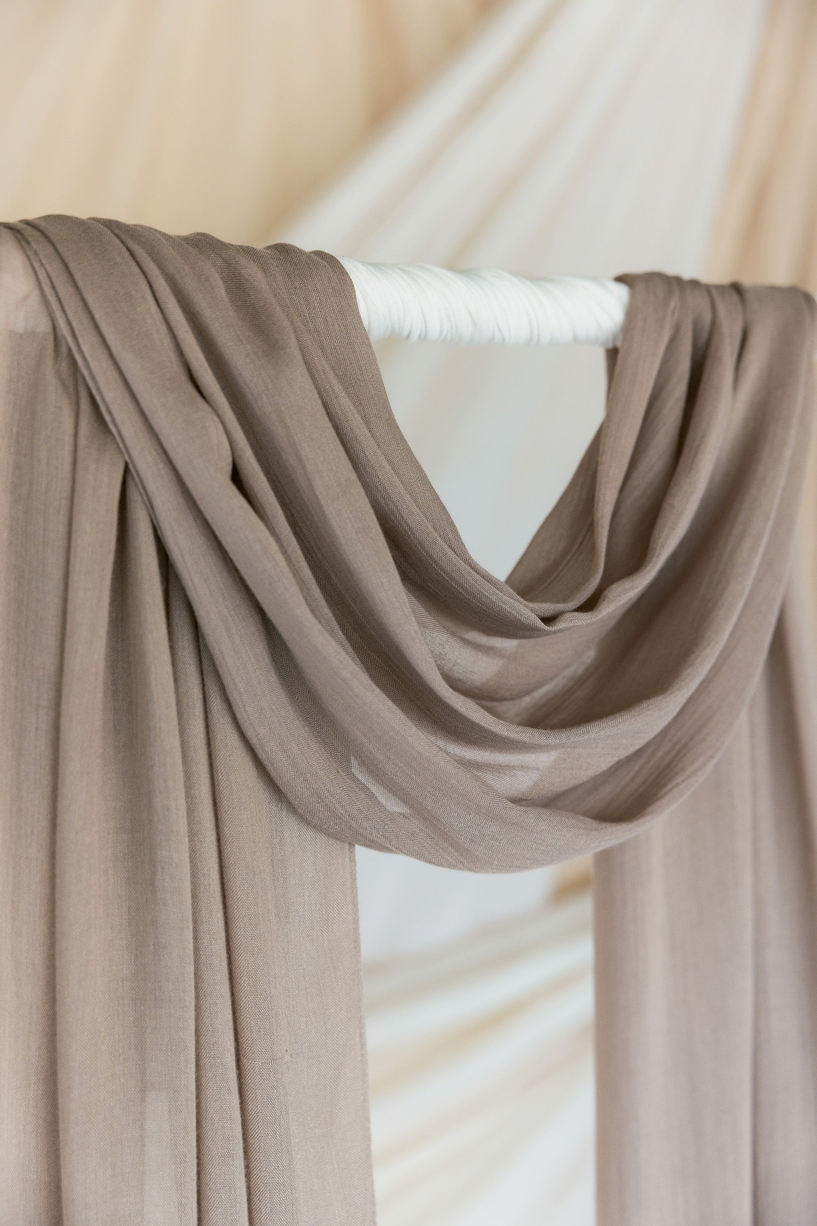 Truffle Mushroom hijab draped in front of backdrop.