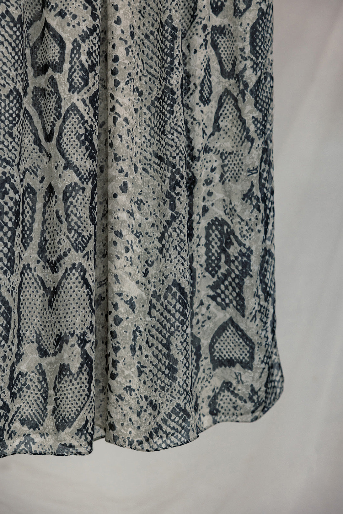 Product shot of Ink Cobra, that displays the snakeskin pattern and white, grey and black tones in the design.