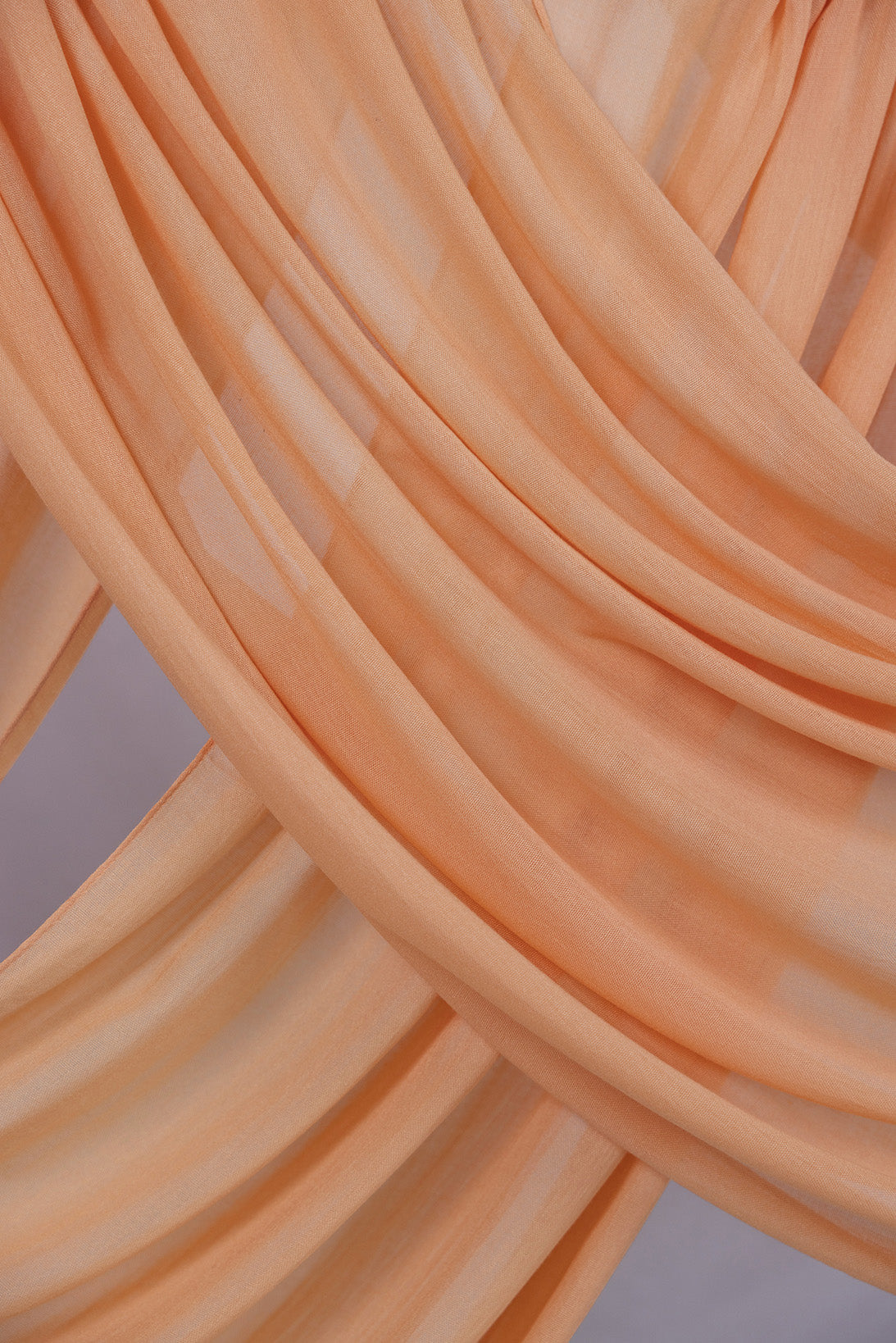 This Golden Hour hijab brings the burnt-gold brilliance of sunset to a clean, modern silhouette