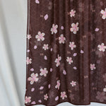 A product image showing a brown hijab printed with pink and white cherry blossoms.