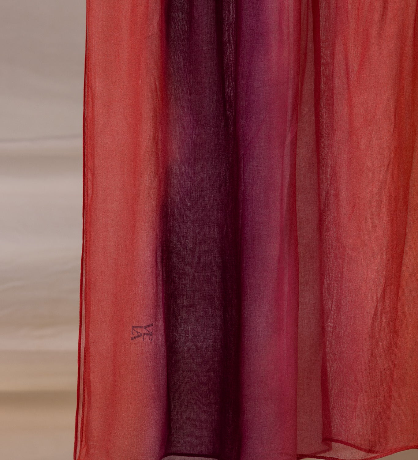 VELA hijab with a soft color blend from deep red to pink, light and comfortable to wear.