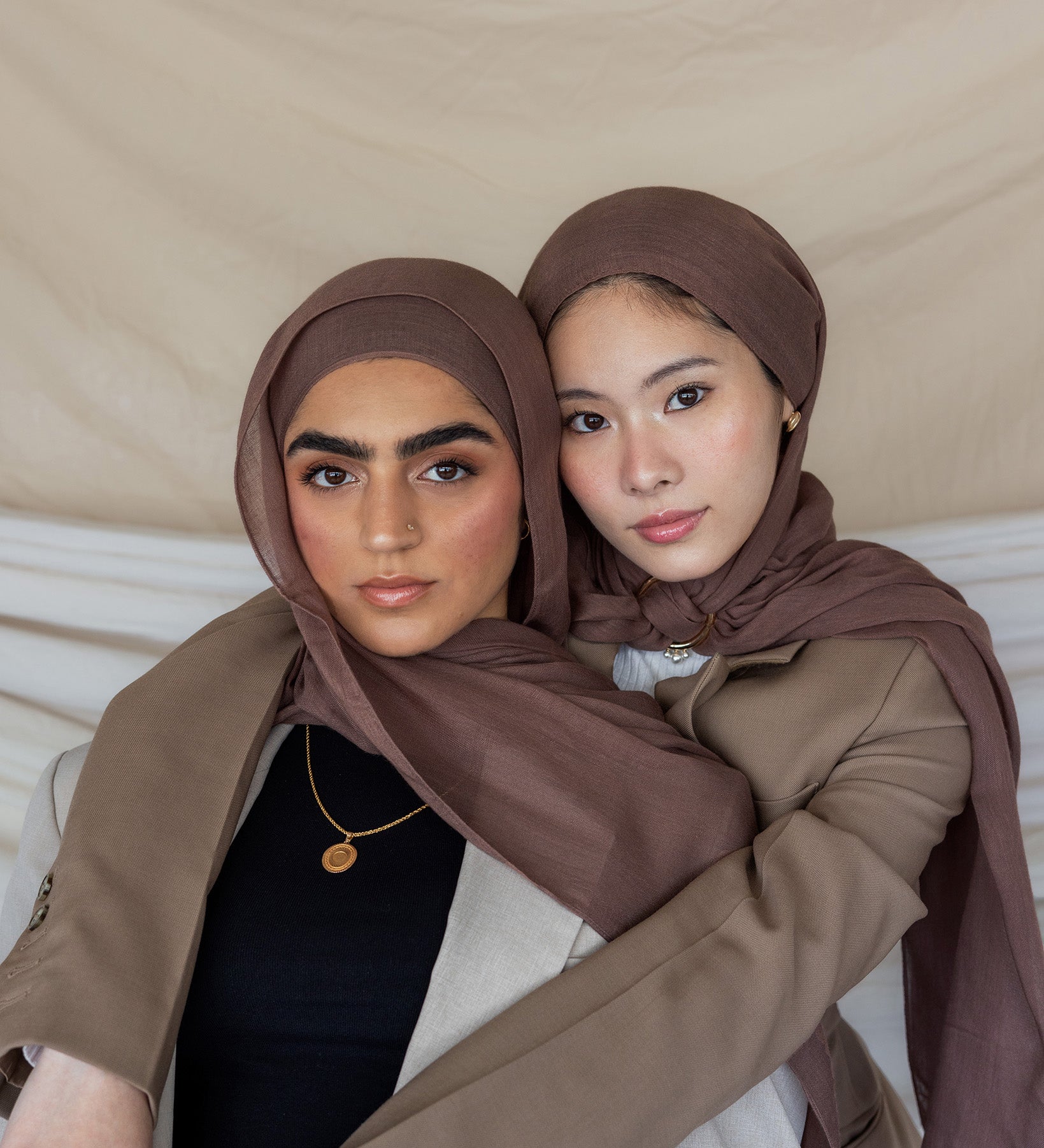 Two individuals wearing taupe-colored hijabs.
