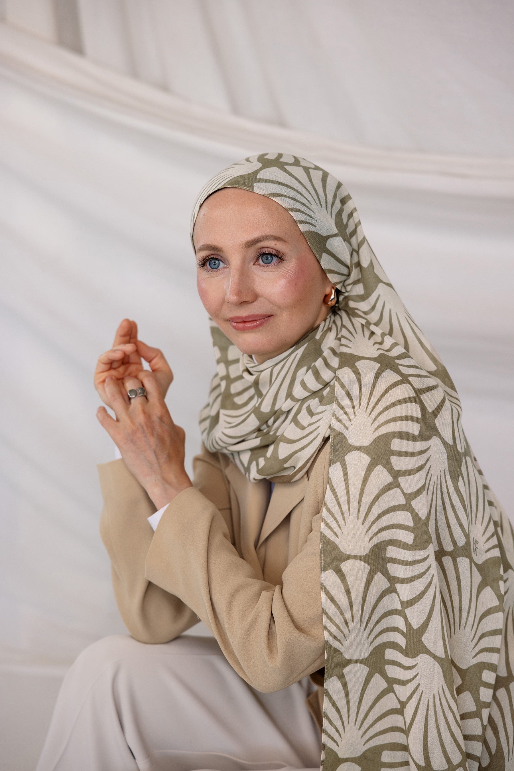 Model wearing Sand Shells patterned hijab against a plain background