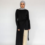 Loose-fitting top with a soft drape and subtle high-low hem for easy layering.