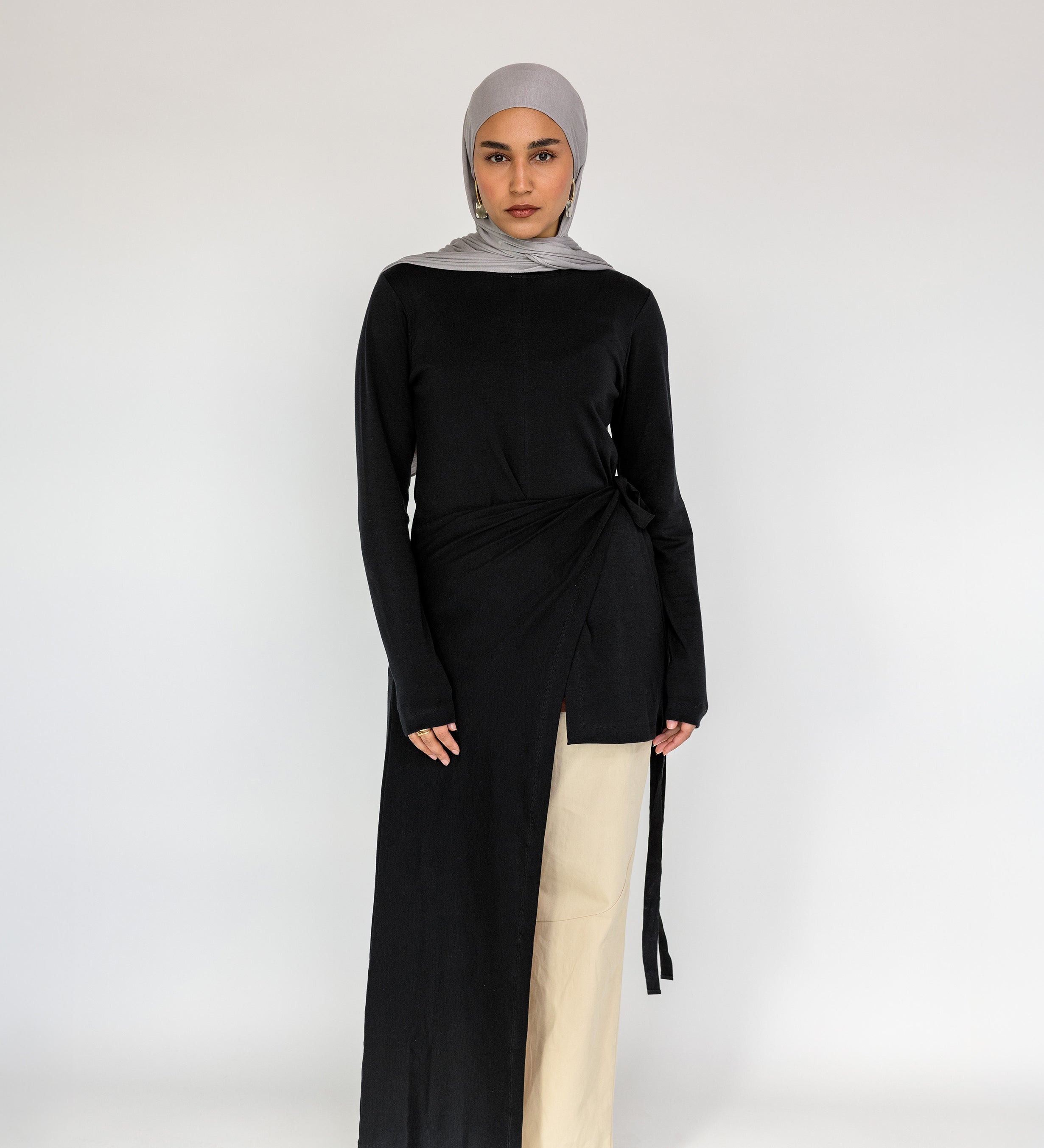 Loose-fitting top with a soft drape and subtle high-low hem for easy layering.